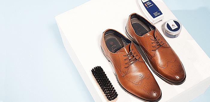 Men's smart brown shoes with shoe cleaning products 
